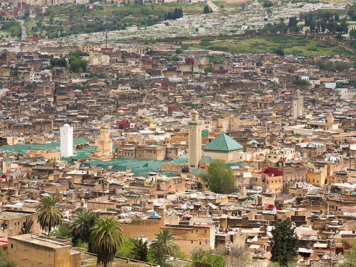 A wide view over the dense rooftops and minarets of the old medina of Fes, Morocco