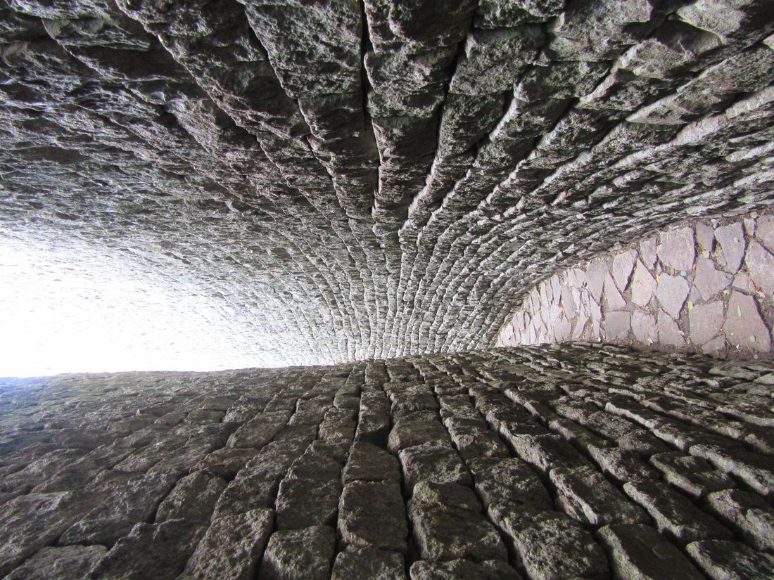 A narrow passage between two high stone walls inside the Great Enclosure