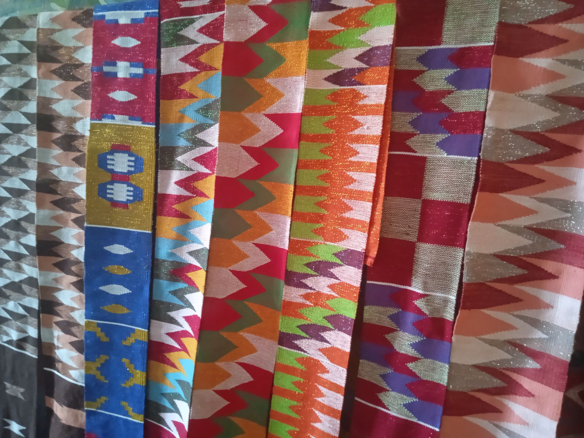 Rows of brightly patterned Ewe kente cloth on display in Tafi, Volta Region, Ghana