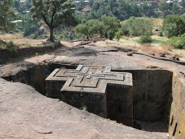 The cross-shaped roof of the Church of Saint George, carved into a pit of red rock in Lalibela, Ethiopia